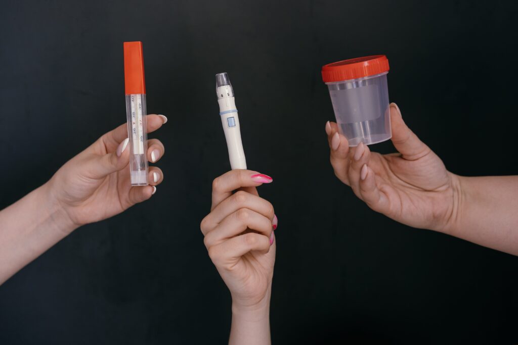 Showing a thermometer and test tube and a medical test sample box
