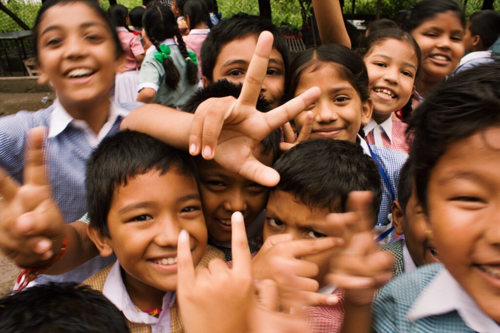 Happy Indian children, playing and showing victory signs, Autism Prevalence in India